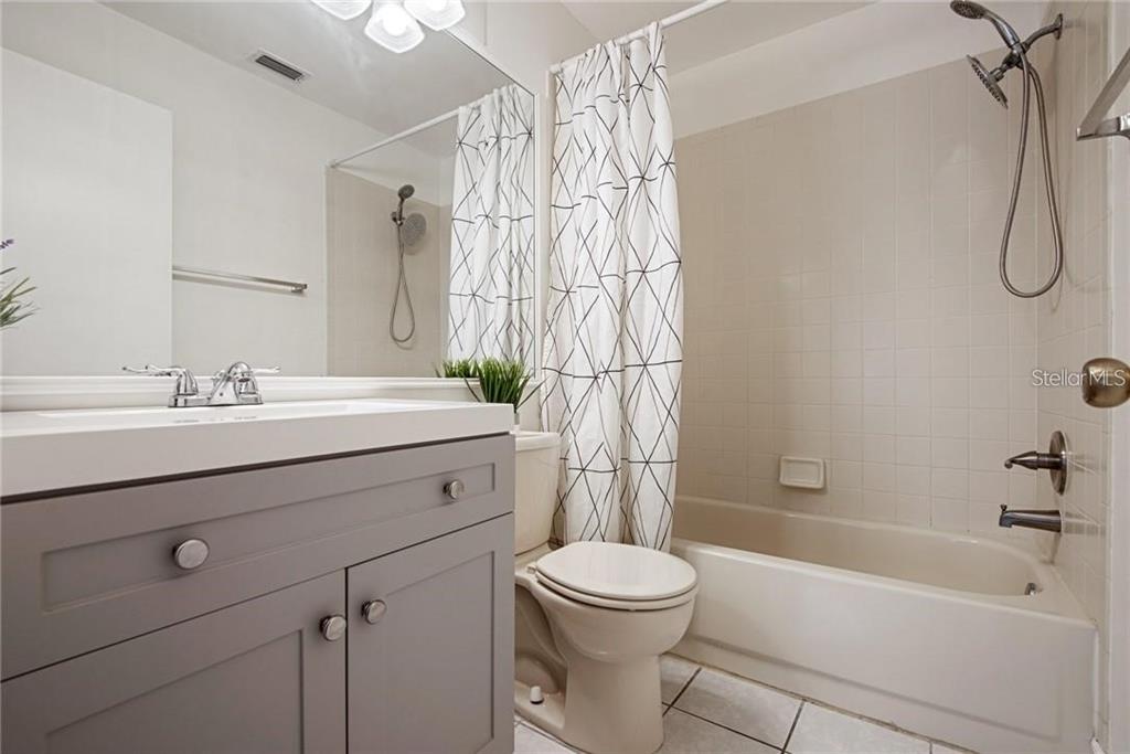 4006 Angel Oak Court, Unit 202 Tampa, FL 33613 - Photo 13 of 15 a bathroom with a sink a toilet and a bathtub