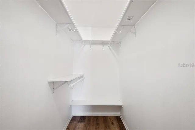 a view of walk in closet with empty racks