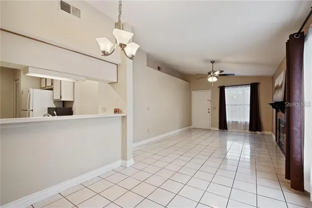 a view of a kitchen with wooden floor and a chandelier