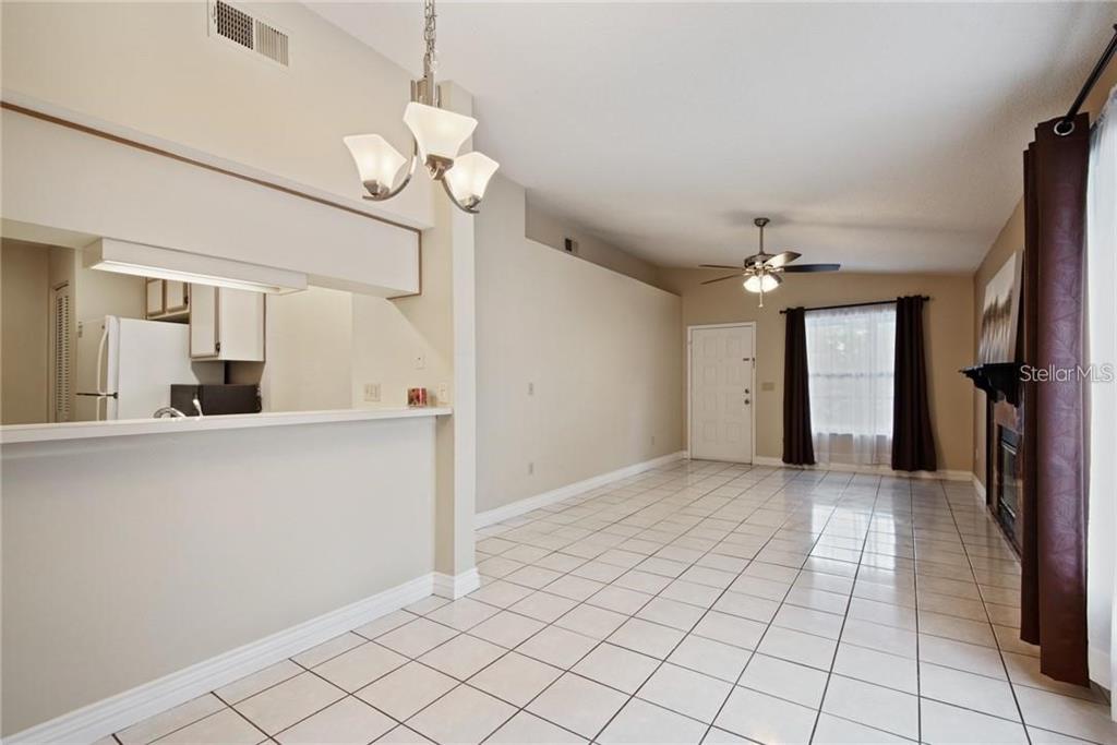 4006 Angel Oak Court, Unit 202 Tampa, FL 33613 - Photo 4 of 15 a view of a kitchen with wooden floor and a chandelier