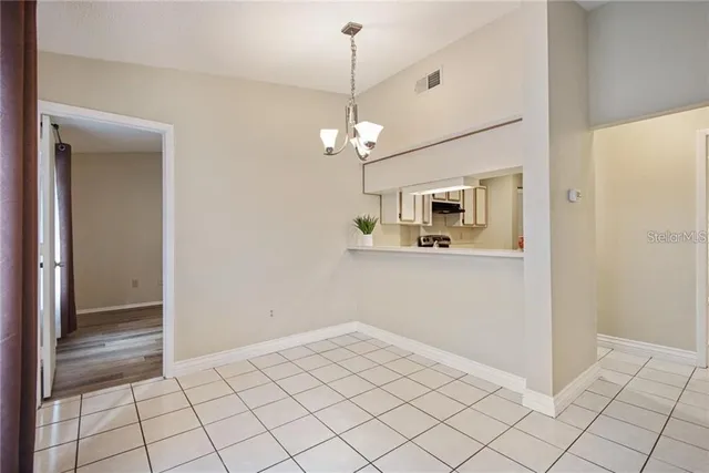 a view of a hallway with chandelier