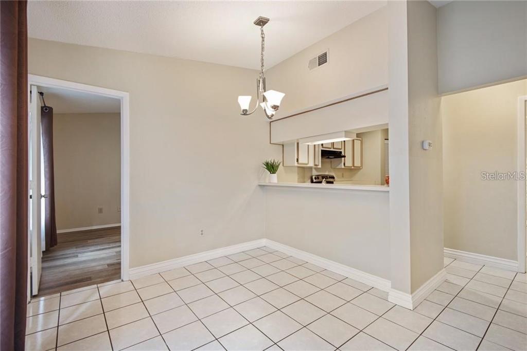 4006 Angel Oak Court, Unit 202 Tampa, FL 33613 - Photo 5 of 15 a view of a hallway with chandelier