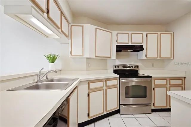 a kitchen with a sink stove and cabinets