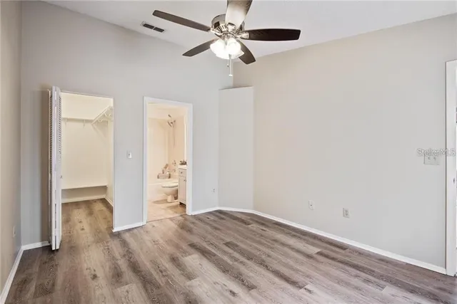 a view of empty room with wooden floor
