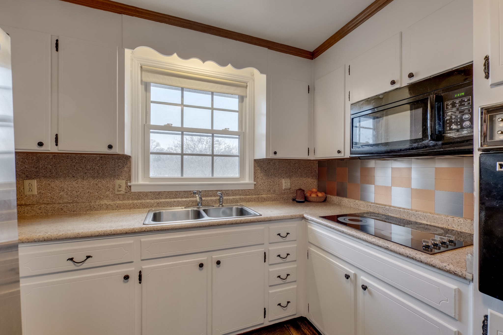 68 Tusculum Road Antioch, TN 37013 - Photo 8 of 25 a kitchen with stainless steel appliances granite countertop white cabinets and a stove top oven