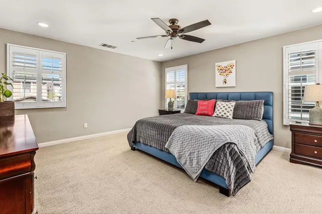 a bedroom with a large bed and a window