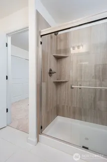 a bathroom with a shower and a bath tub