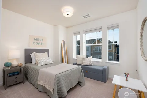 a bedroom with a bed and a large window