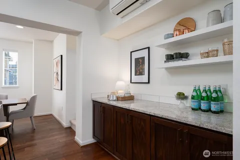 a kitchen with stainless steel appliances granite countertop a sink and wooden floor