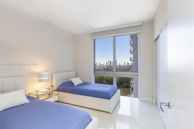 a bedroom with a bed and a large window