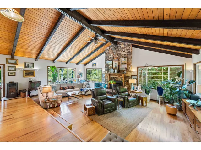 a living room with furniture a wooden floor and next to a window