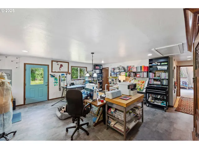 a living room with lots of furniture and a large window