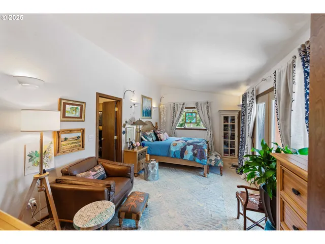 a view of a livingroom with furniture bookshelf and a wooden floor