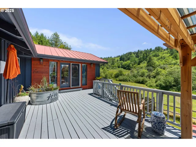a view of a house with a deck and a garden