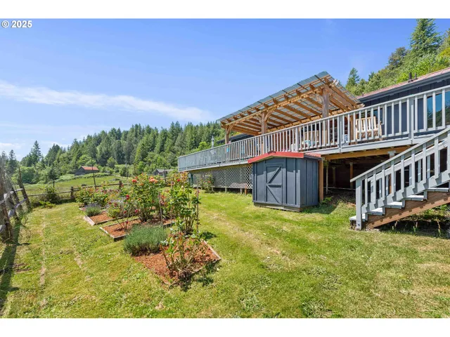 a backyard of a house with table and chairs