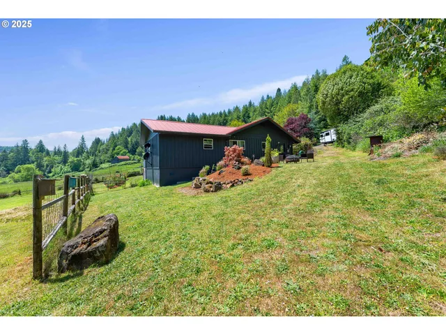 a view of a backyard with plants and a patio