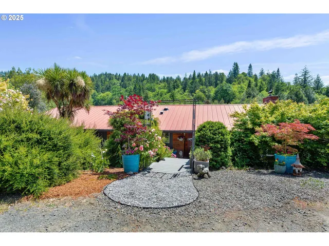 a view of a patio with table and chairs and potted plants