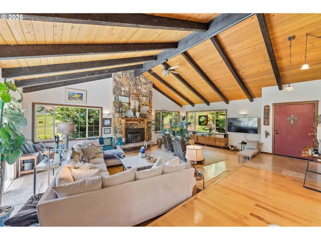 a living room with lots of furniture and floor to ceiling windows