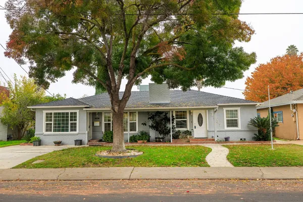 a front view of a house with a garden
