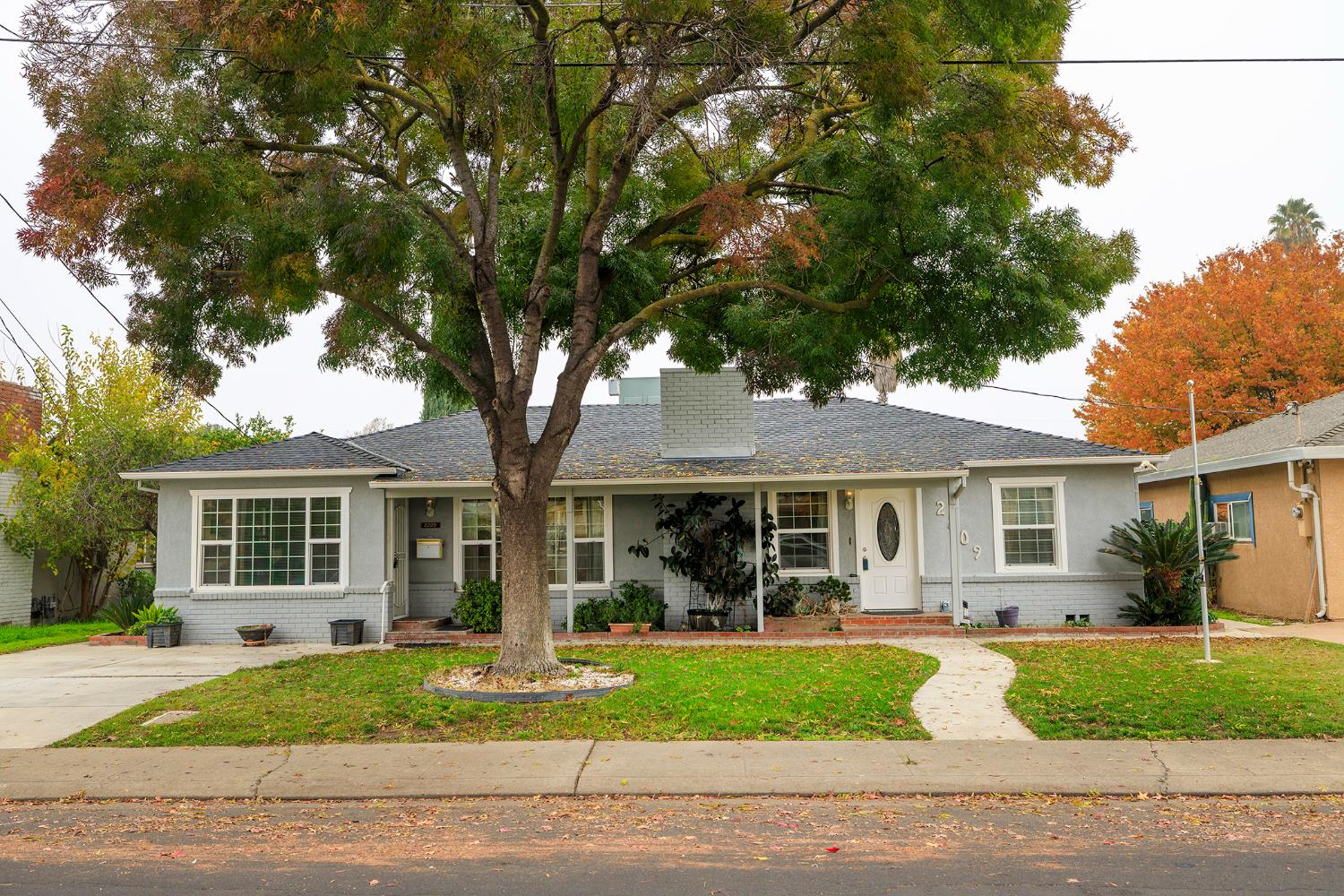 a front view of a house with a garden