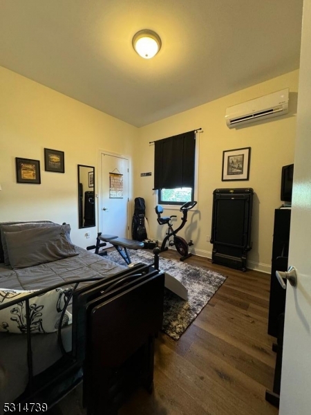 183 Garibaldi Avenue, Unit 207 Lodi, NJ 07644 - Photo 7 of 10 a living room with furniture and a flat screen tv