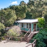 a view of a chair and table on the wooden deck