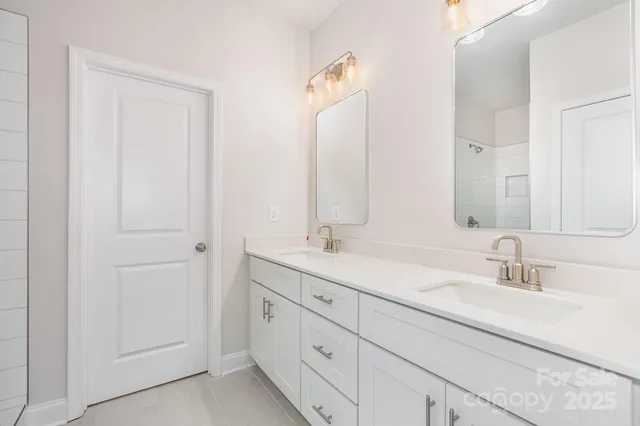 a bathroom with 2 sink and a mirror