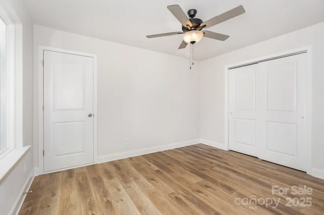 a view of a room with a ceiling fan