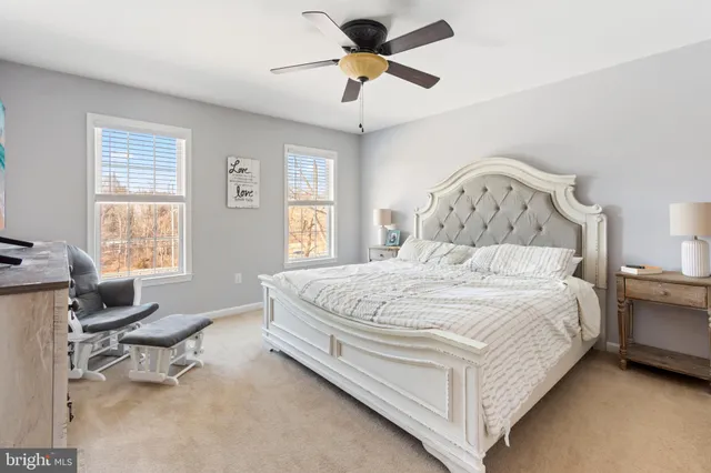 a large bed sitting in a bedroom next to a window