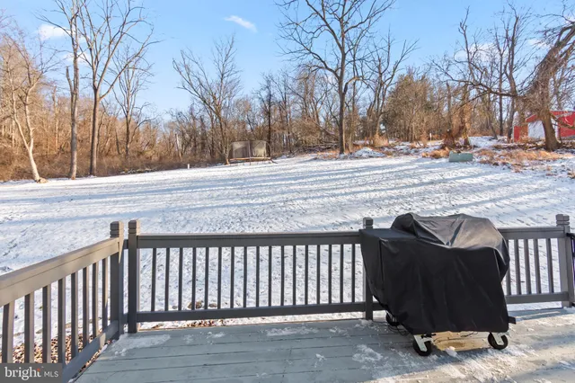 a view of a house with cars park side of the road