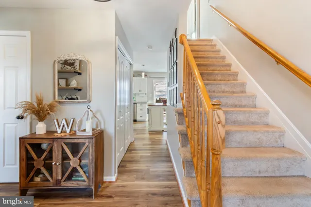 a view of hallway with wooden floor