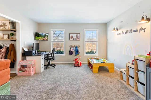 a living room with furniture toys and a flat screen tv