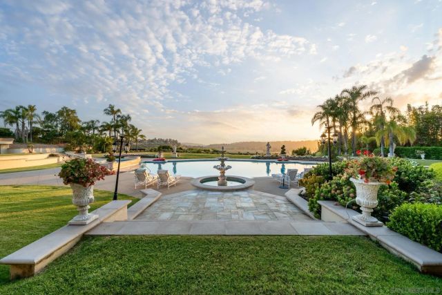 swimming pool view with a garden