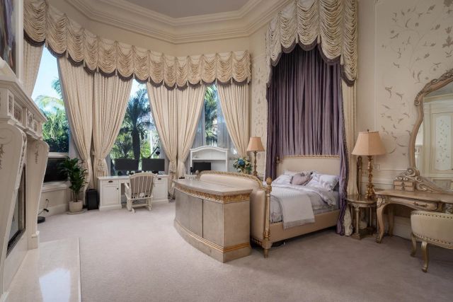 a bathroom with a granite countertop sink a mirror and shower