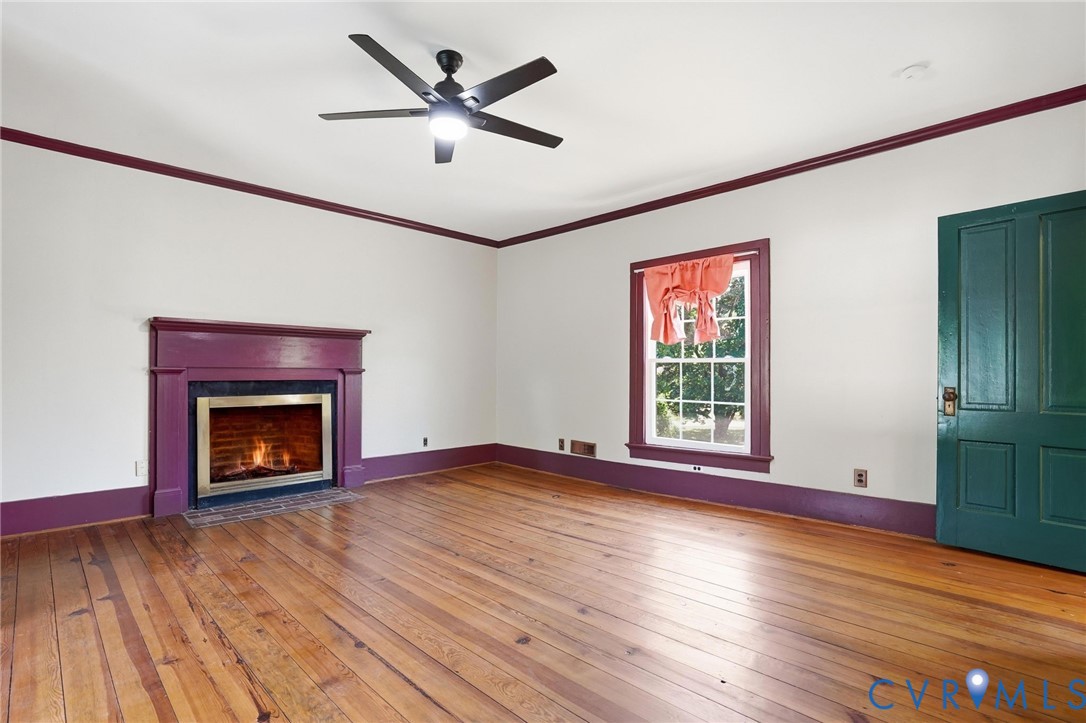 2297 Indian Oak Road Crewe, VA 23930 - Photo 24 of 53 a view of an empty room with wooden floor fireplace and a window