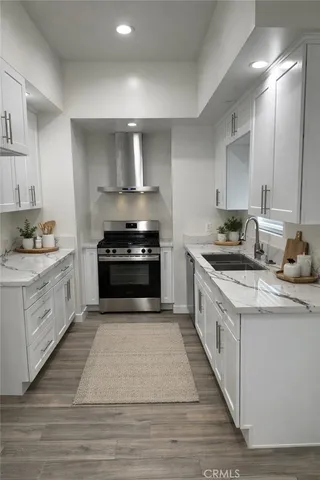 a kitchen with granite countertop a sink and cabinets