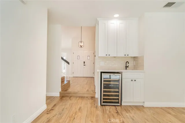 a view of a room with wooden floor and a ceiling fan