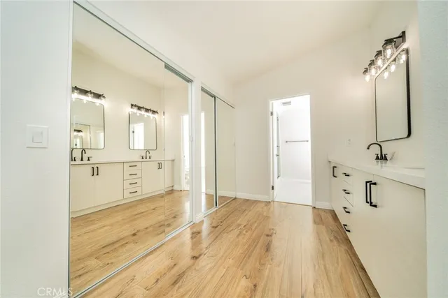 a view of a room with wooden floor and a ceiling fan