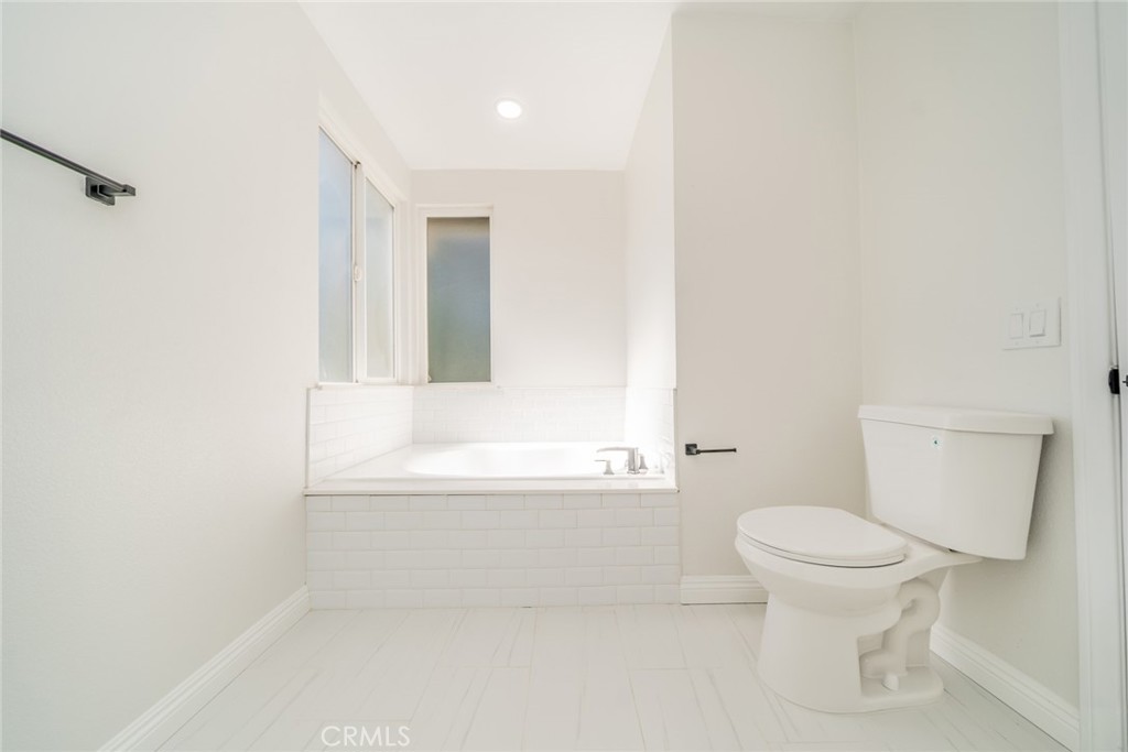 3 Wild W Circle Phillips Ranch, CA 91766 - Photo 30 of 65 a bathroom with a toilet and a bathtub