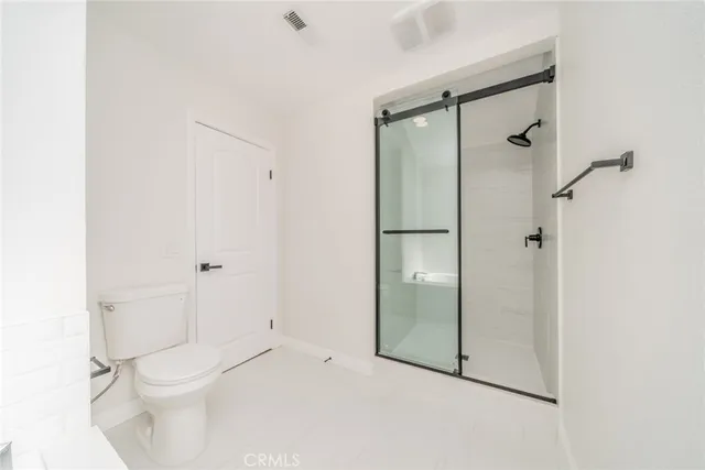 a bedroom with a bed and a potted plant