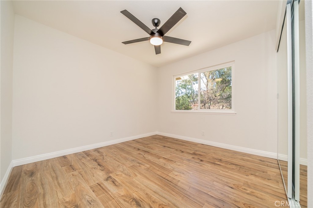 3 Wild W Circle Phillips Ranch, CA 91766 - Photo 36 of 65 an empty room with wooden floor and ceiling fan