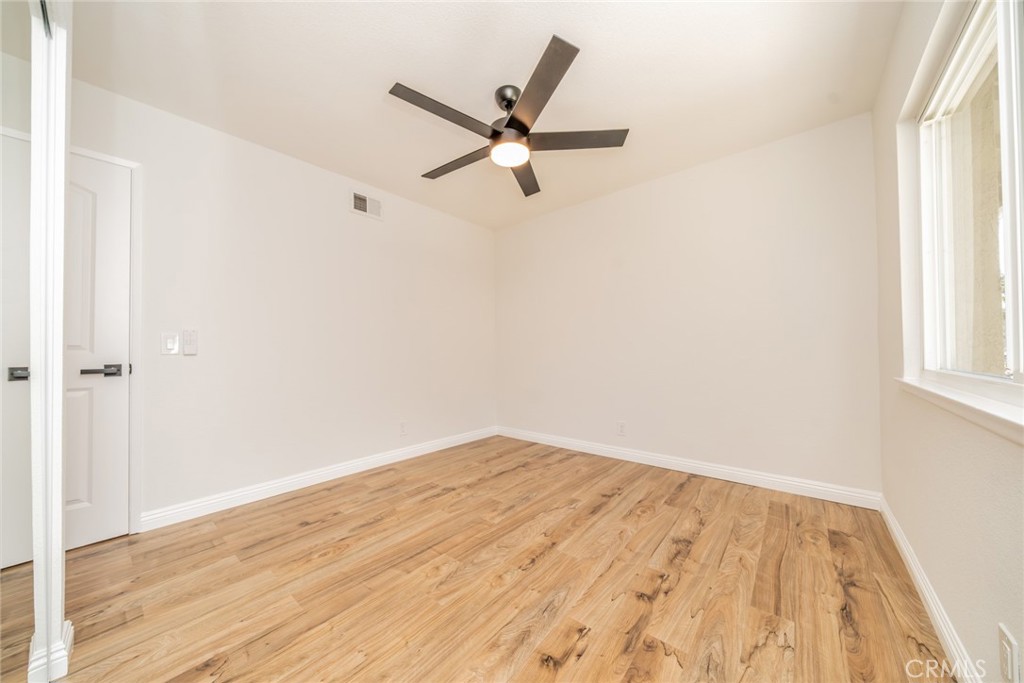 3 Wild W Circle Phillips Ranch, CA 91766 - Photo 38 of 65 a view of a room with wooden floor and a ceiling fan