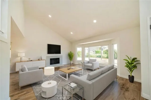 a living room with furniture a fireplace and a flat screen tv