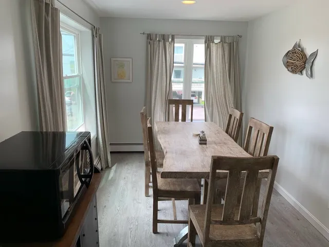 a dining room with furniture and window