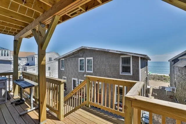 a view of a house with wooden fence and large windows