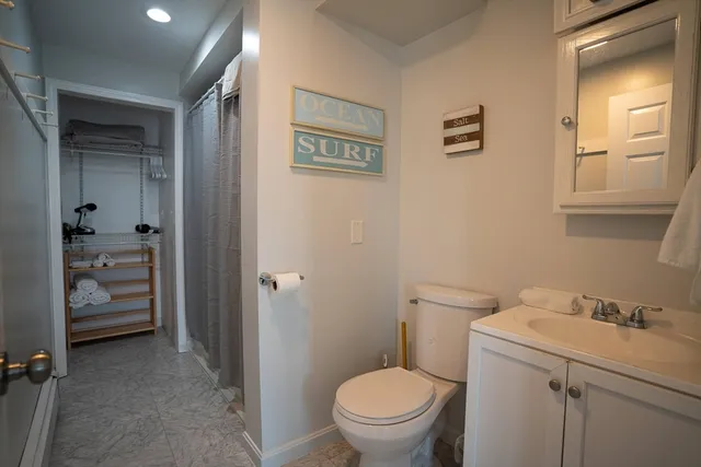 a bathroom with a toilet sink and shower