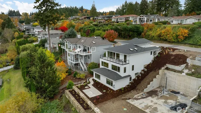 an aerial view of multiple houses with a yard