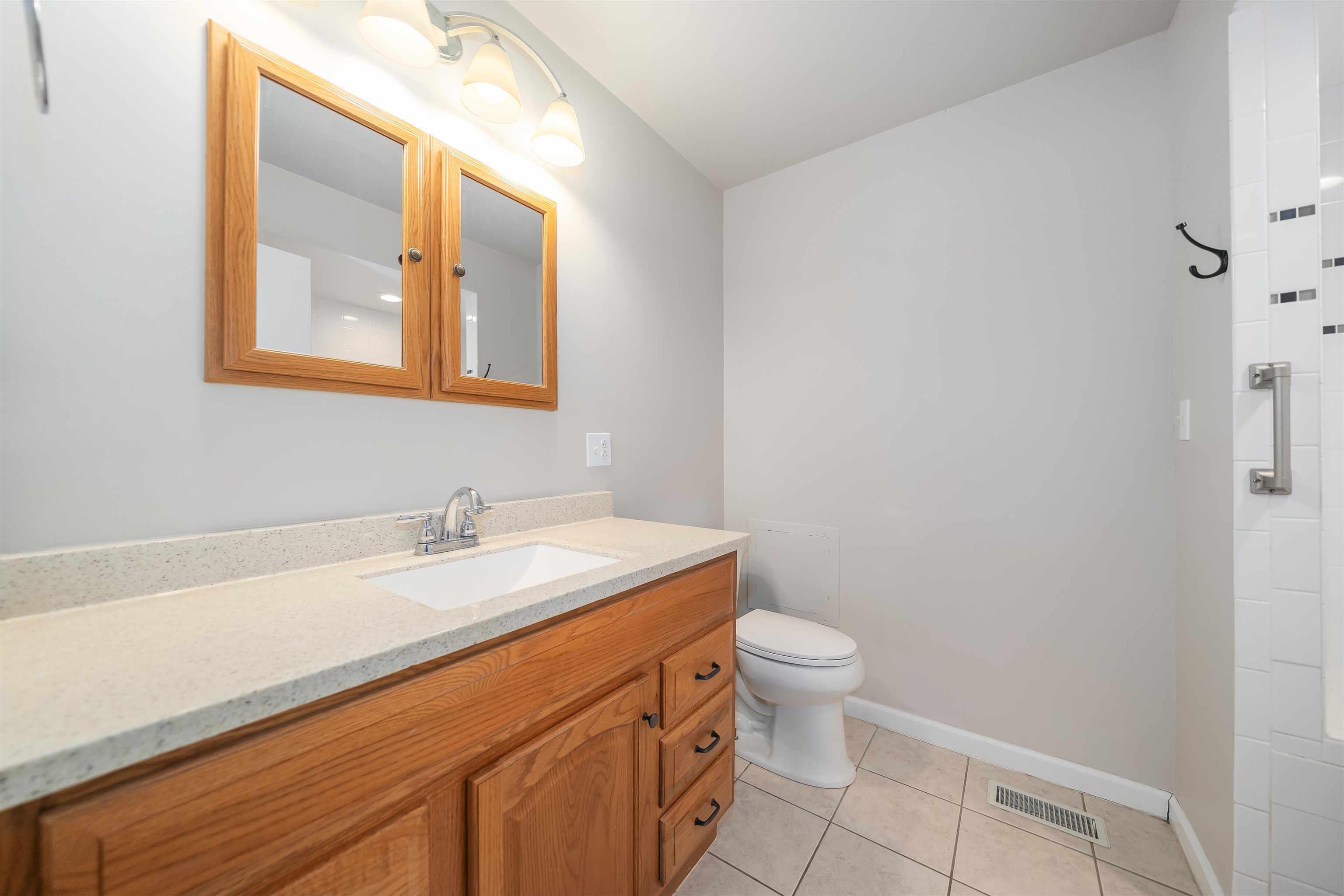 1070 Pine Top Road Toone, TN 38381 - Photo 15 of 30 a bathroom with a granite countertop sink a toilet and a mirror