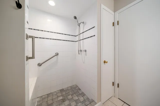 a bathroom with a shower and a shower