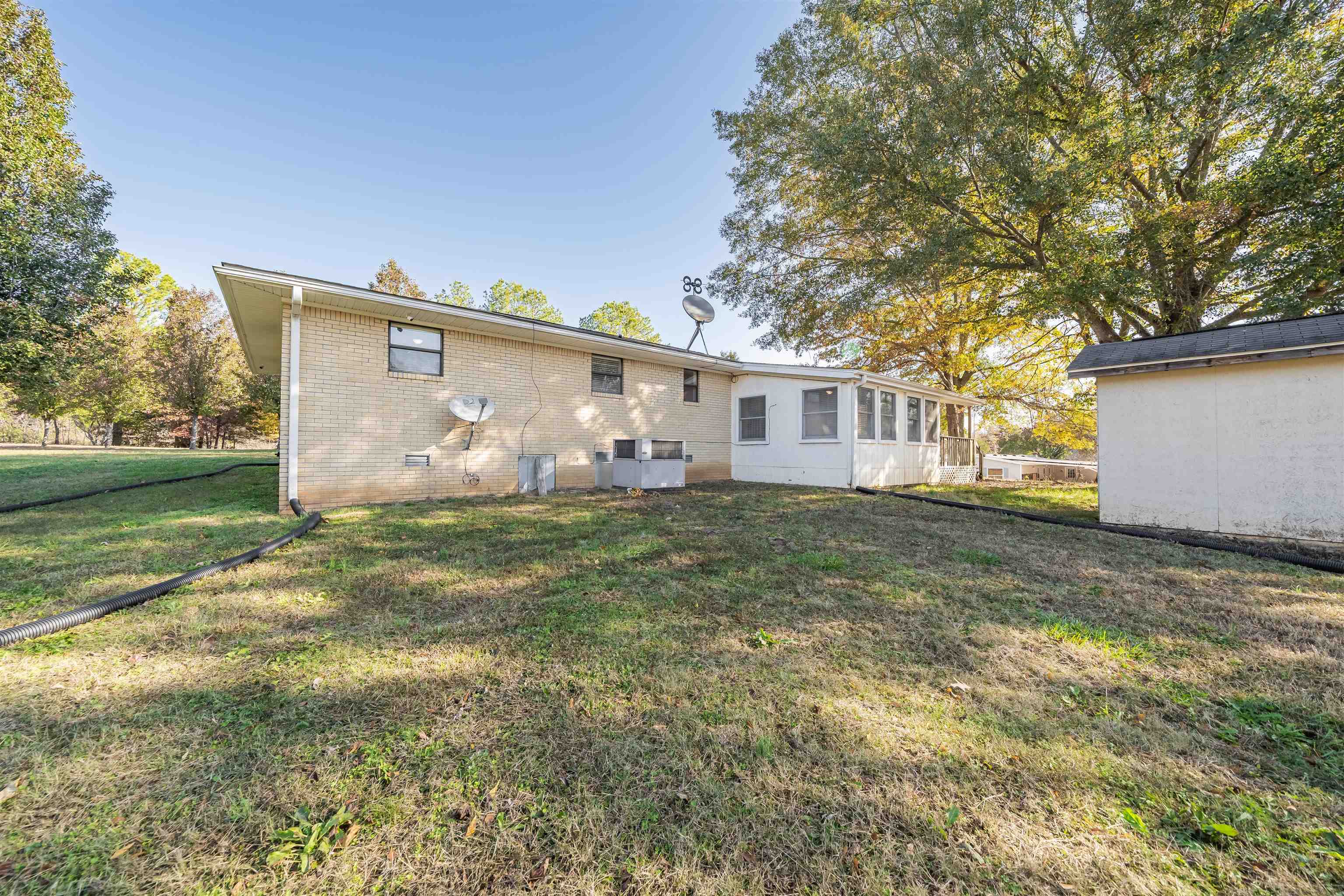 1070 Pine Top Road Toone, TN 38381 - Photo 21 of 30 a view of a house with backyard and sitting area